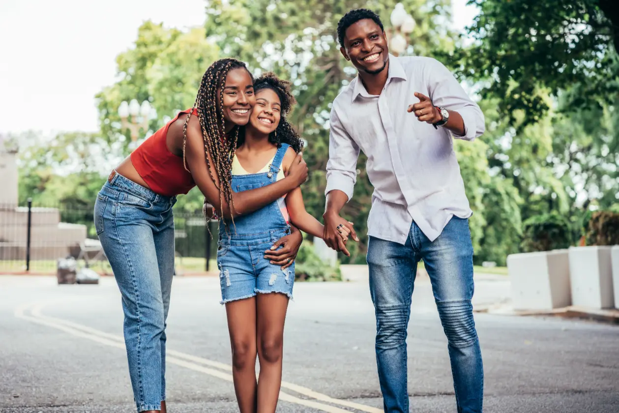 service-1-1 african american family enjoying day together while walking outdoors street urban concept
